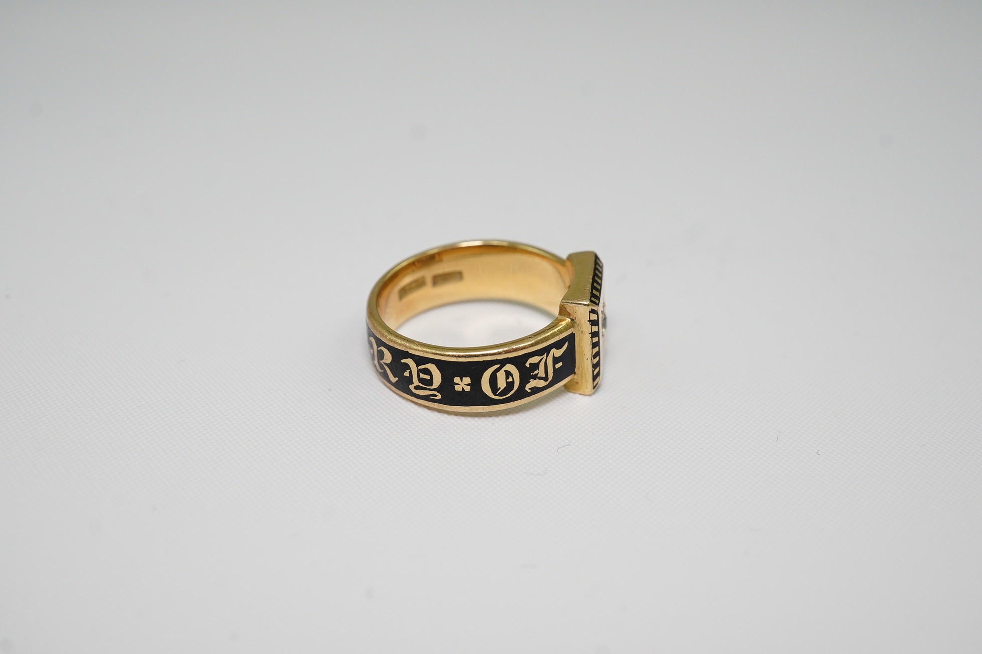 A 19th century 18ct gold, black enamel and single stone diamond set 'In Memory Of' ring